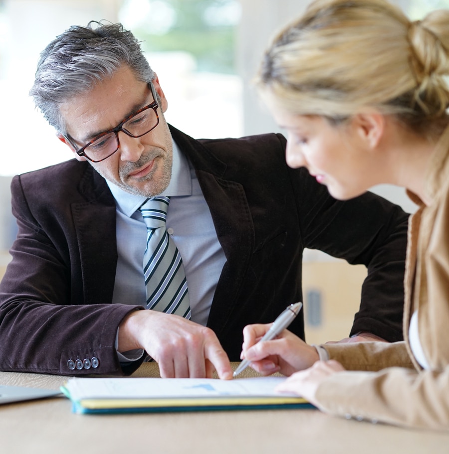 a group of people looking at a laptop